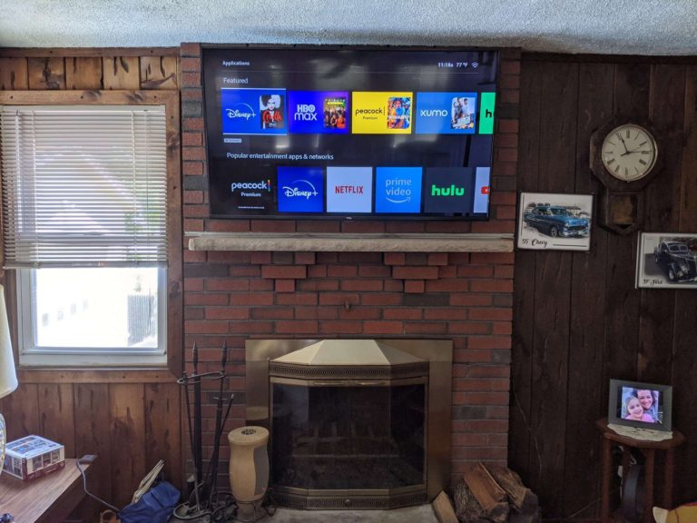 TV mounting above brick fireplace.